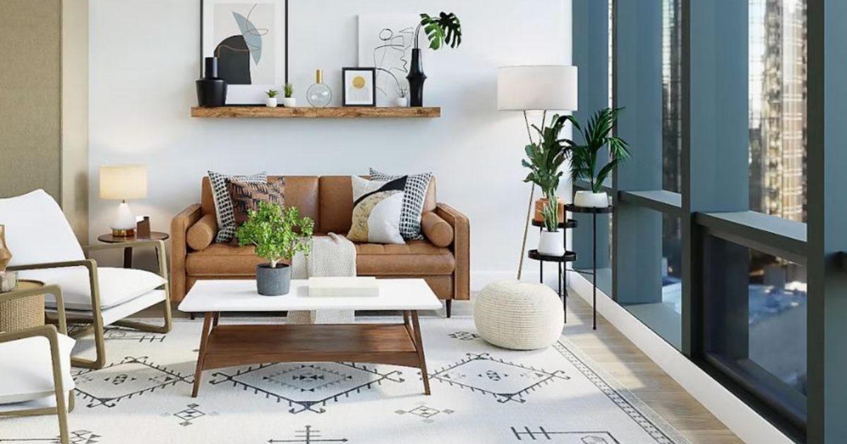 Living room with a tan sofa, white coffee table and floor-to-ceiling windows